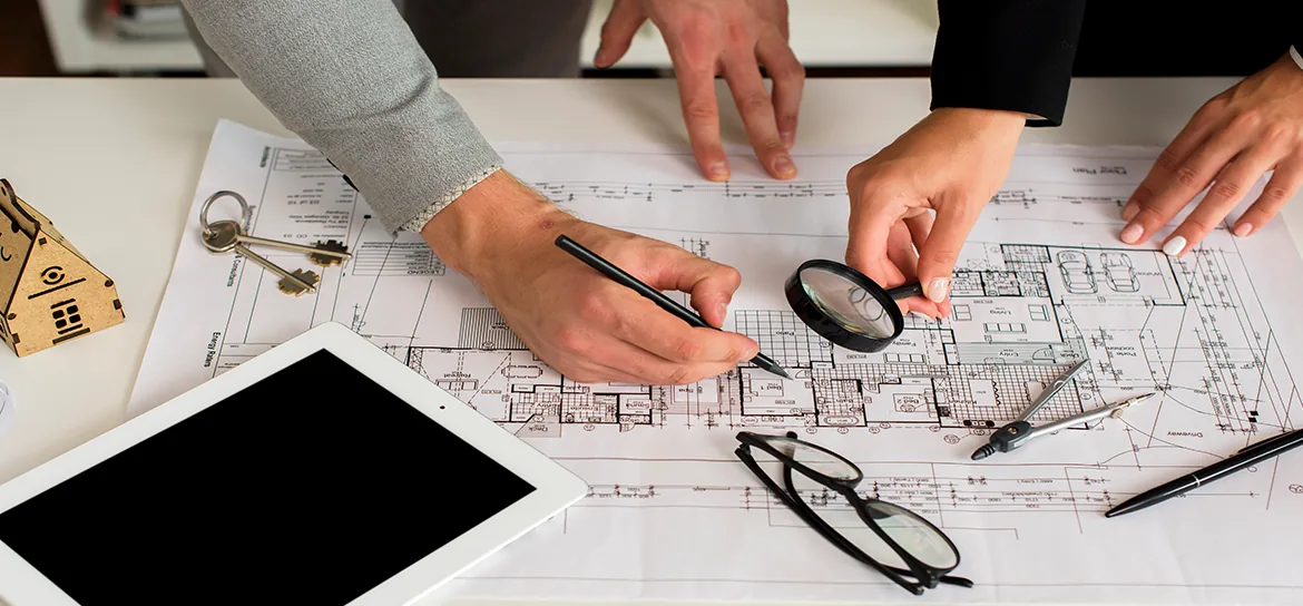 Construction plans and layout tools on a project desk