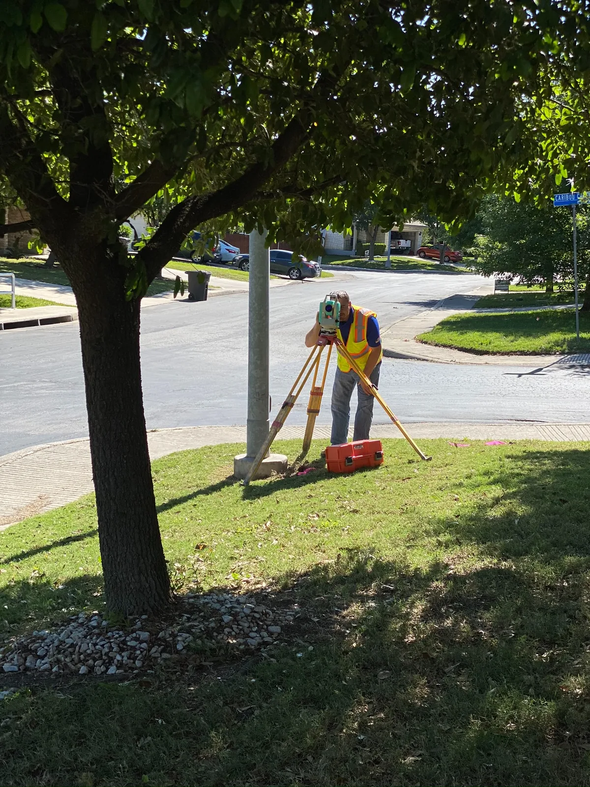 Surveyor operating a total station during fieldwork on a Texas property